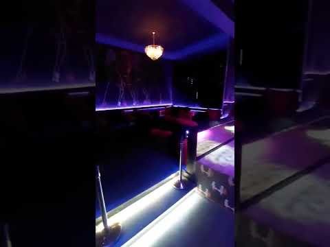 Dark neon-lit interior of an Athens night venue