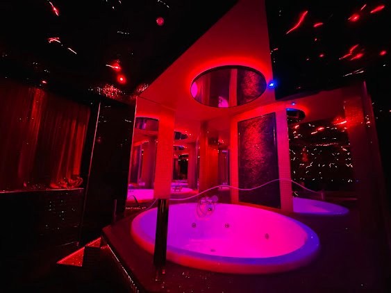 Red and pink neon lit club interior in Athens