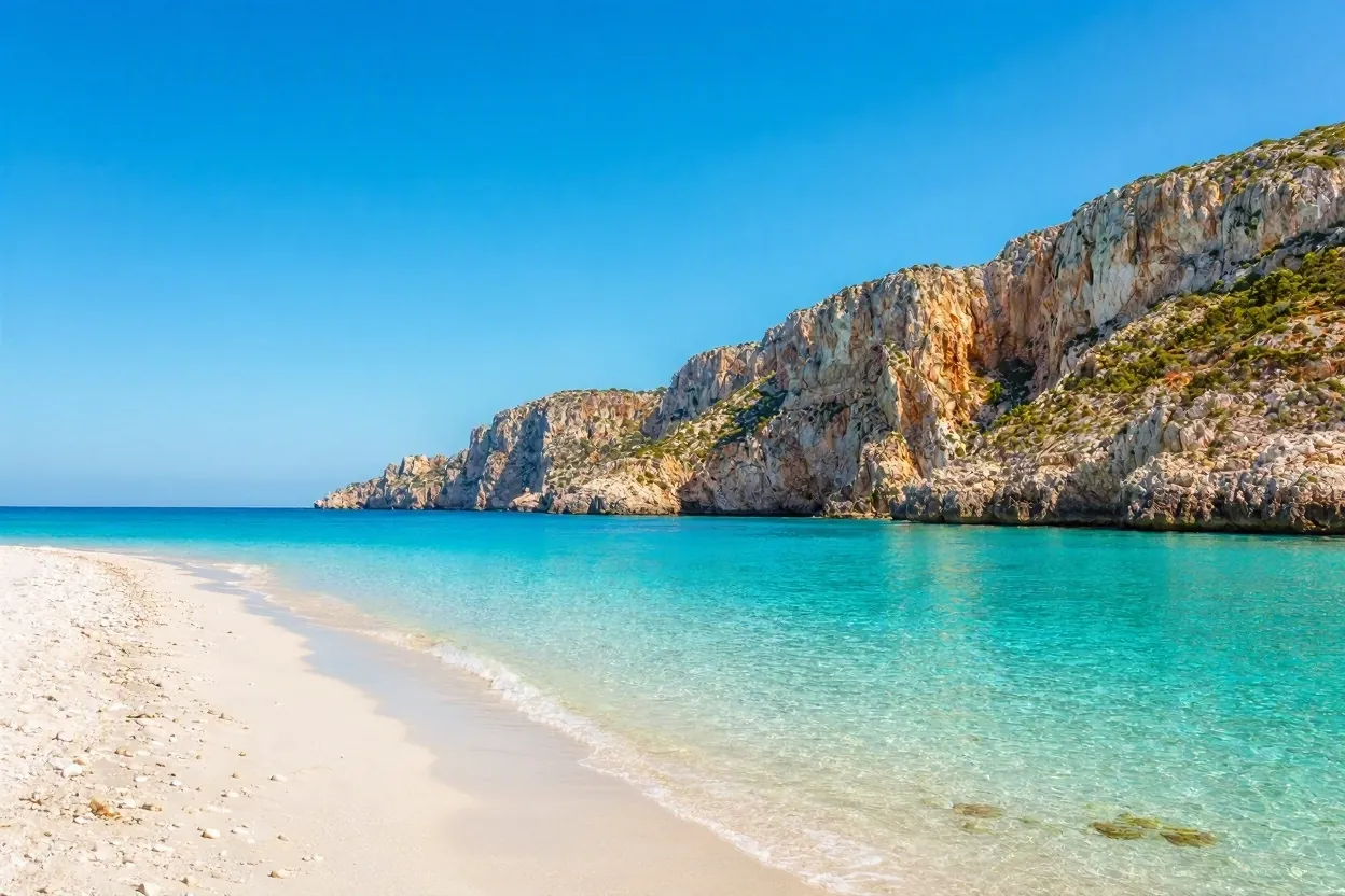 Turquoise sea and white sand beach along the Greek coastline