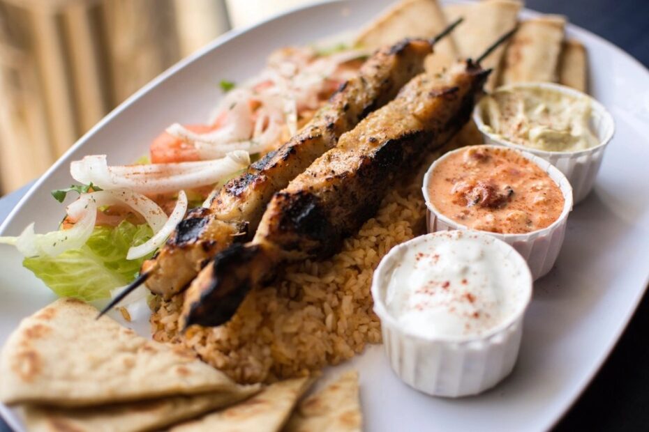 Plate of grilled Greek meze with dips and flatbread