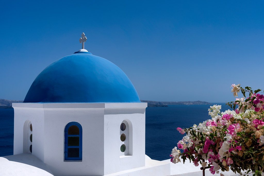 Blue-domed church above the sea on Santorini
