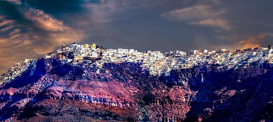 Santorini village lights along the cliff at night