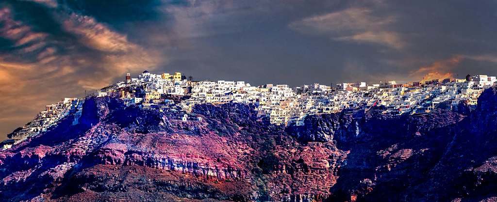 Santorini village lights along the cliff at night